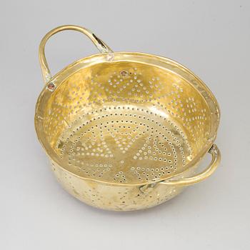 A 19th century brass colander.