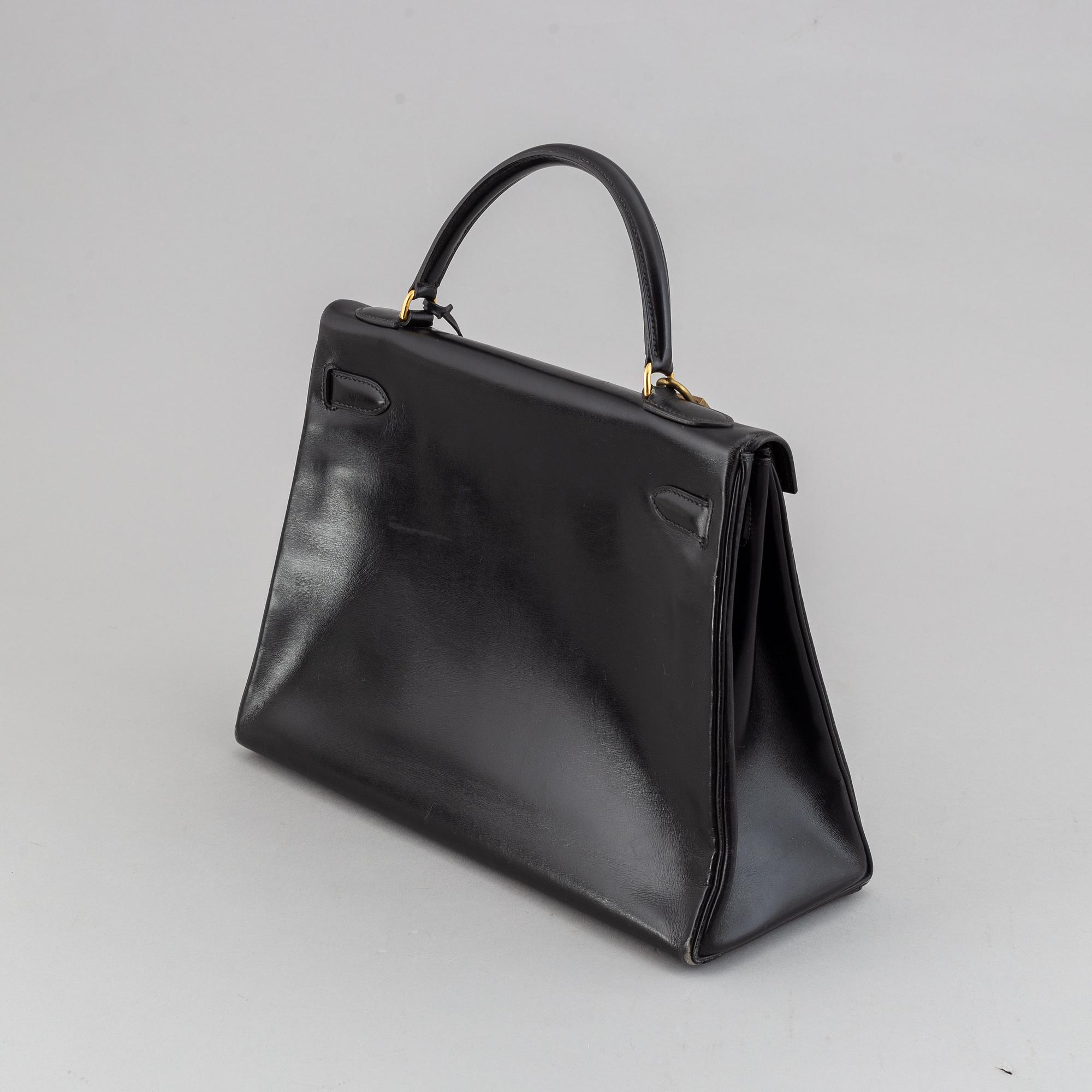Hermès,a black leather 'Kelly 32' handbag, 1975.