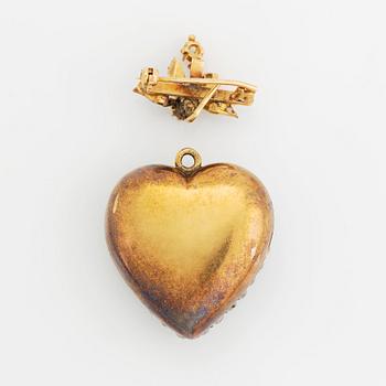 A pendant/locket in 18K gold set with old-cut diamonds, in the form of a heart.