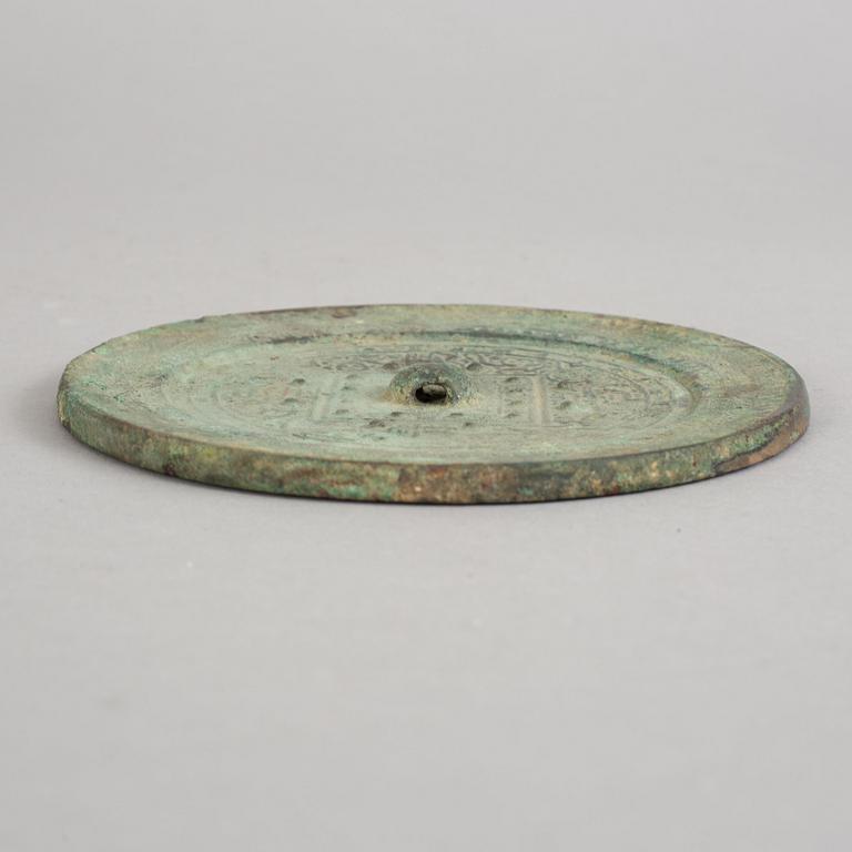 A bronze mirror, Xin-Eastern Han dynasty (9-220).