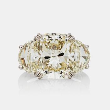 663. A cushion-cut diamond ring. Center diamond 8.08 ct. Quality circa L-M/SI1. Epaulette-cut side stones 2.63cts in total.