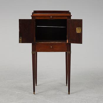 A first half of the 19th century mahogany veneered bedside table.