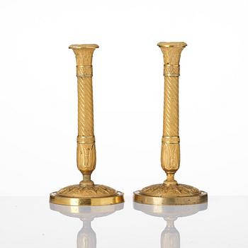 A pair of French Empire ormolu candlesticks, Paris, early 19th century.