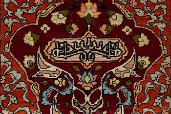 A silk and metal Hereke rug, West Anatolia, c. 58 x 39 cm.