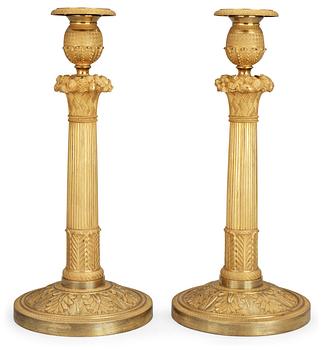 618. A pair of French Empire early 19th century candlesticks.