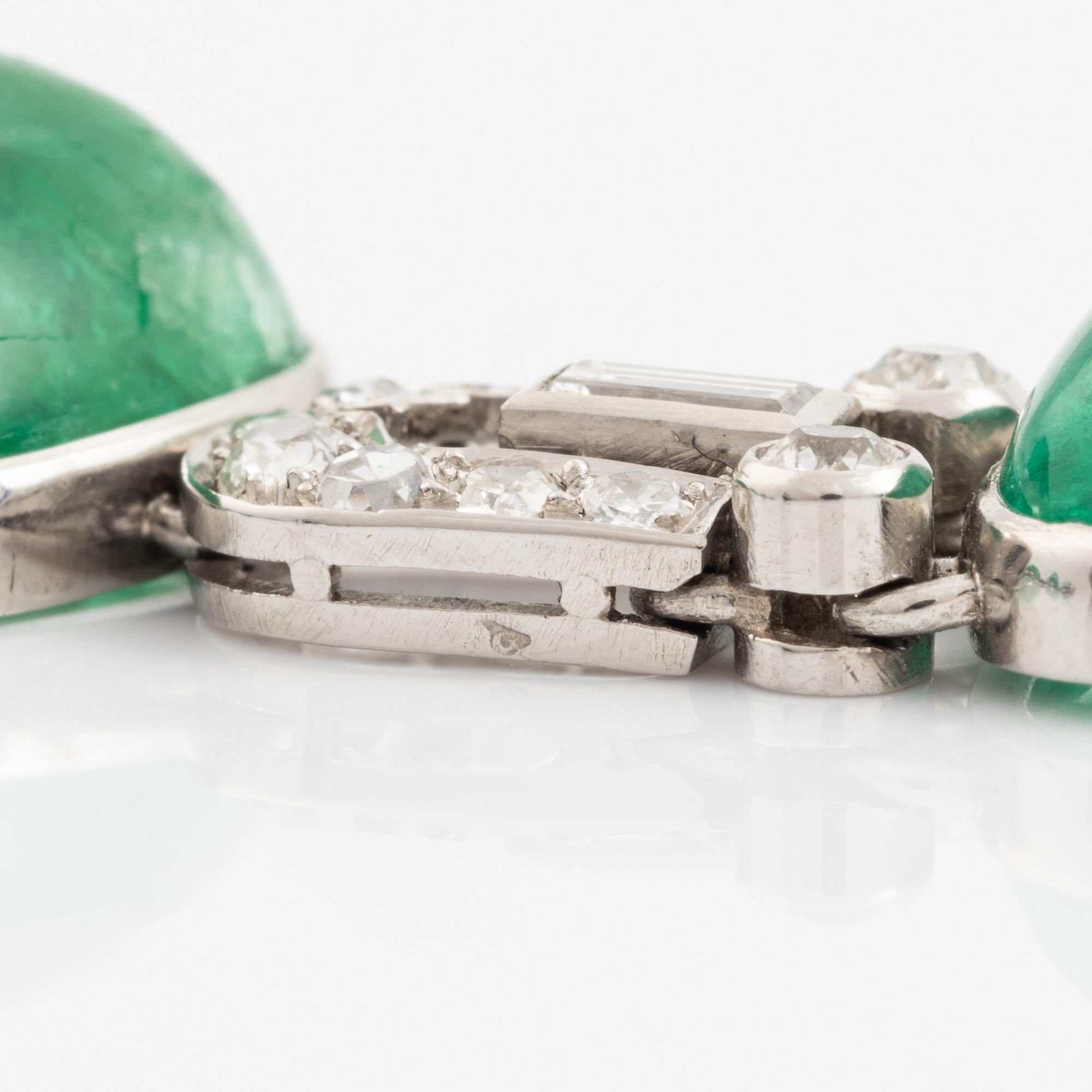 An art deco platinum necklace/bracelet combination with cabochon-cut emeralds.