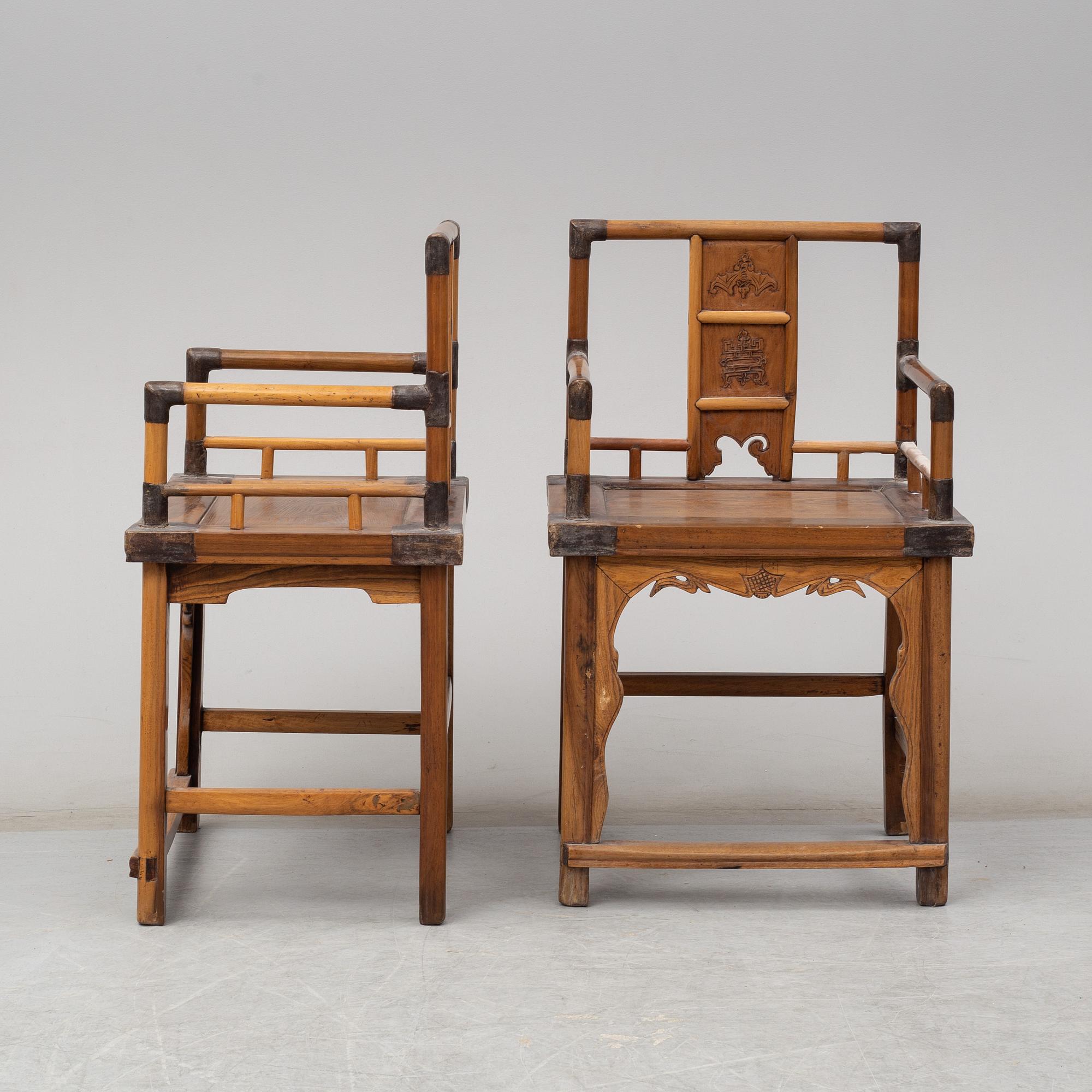 A pair of Chinese wooden armchairs, late 19th/early 20th century.