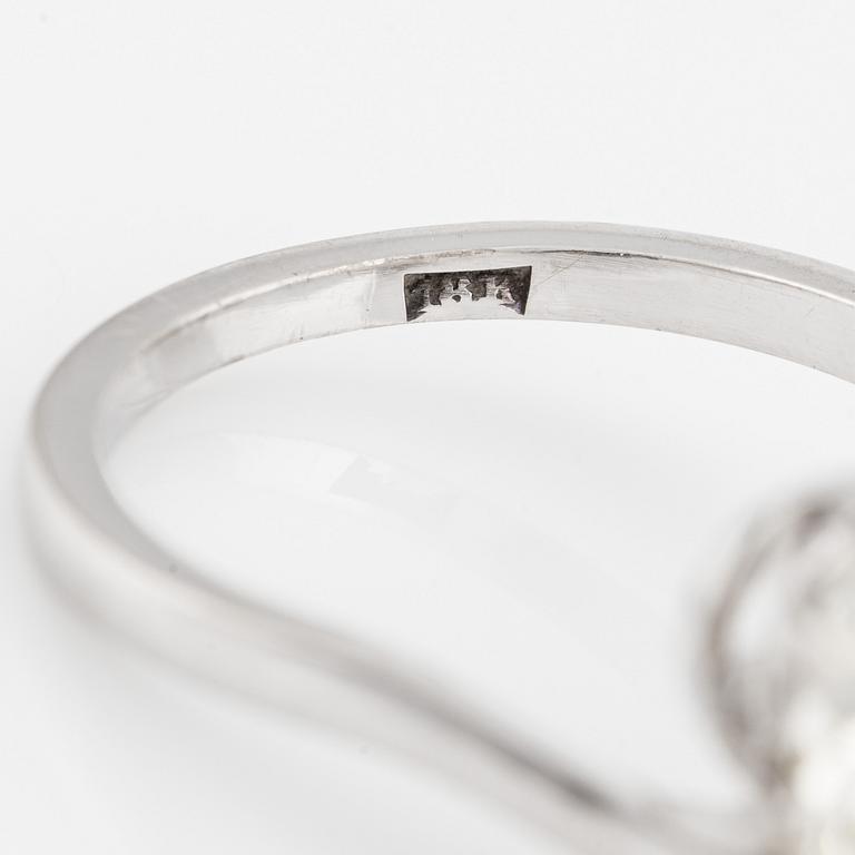 An 18K white gold cross over ring with old-cut diamonds.