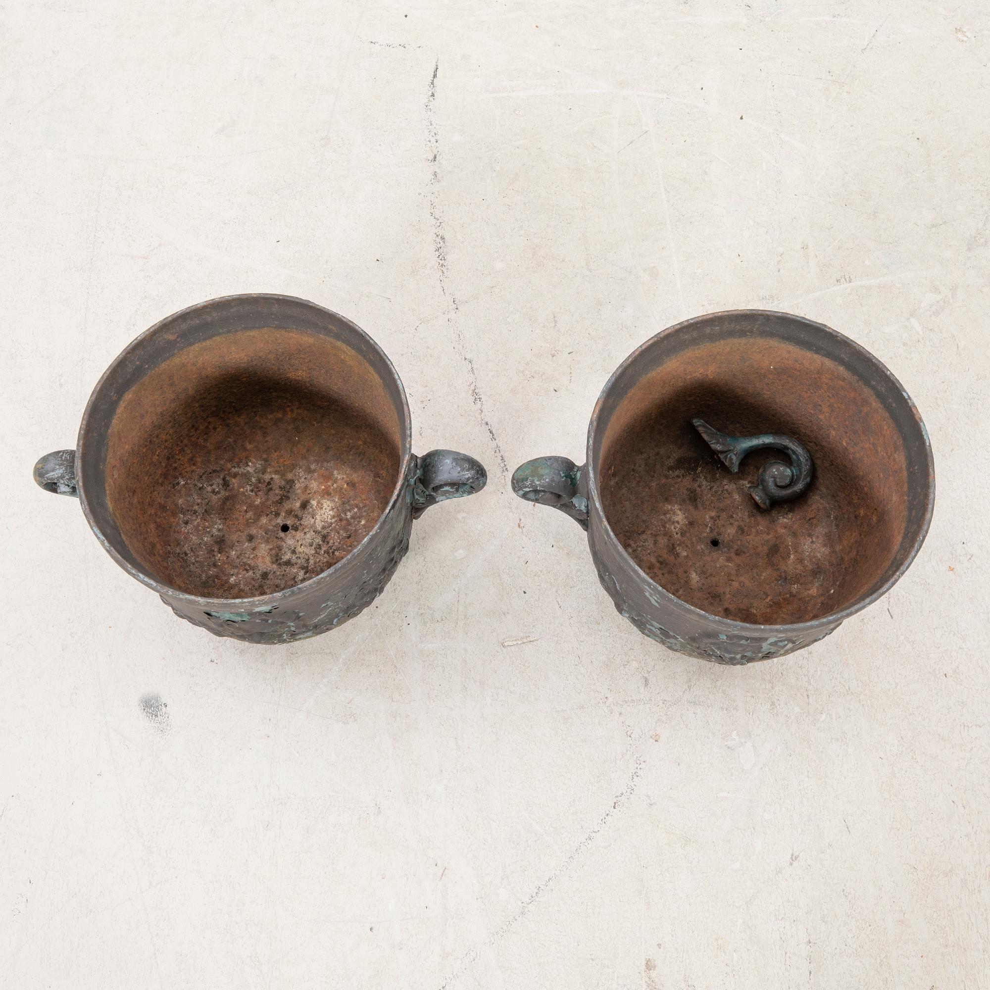 A pair of cast iron garden urns first half of the 20th century.