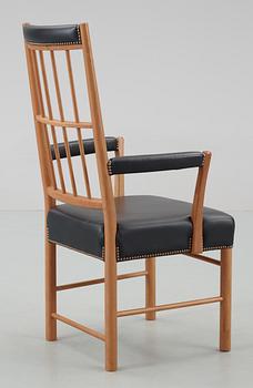 A Josef Frank cherrywood and black leather armchair by Svenskt Tenn, model 652.