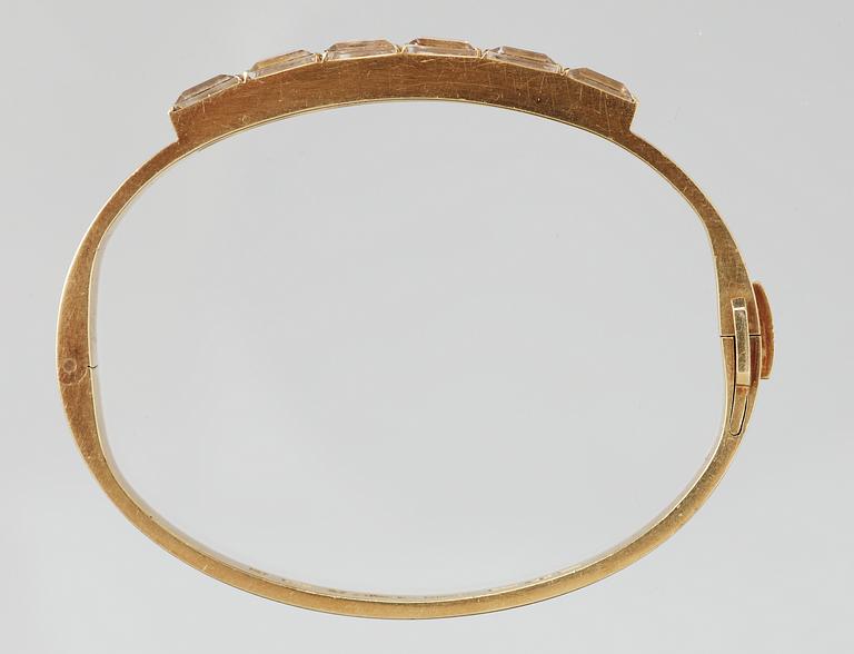 A Wiwen Nilsson 18k gold bangle with facet cut beryls.