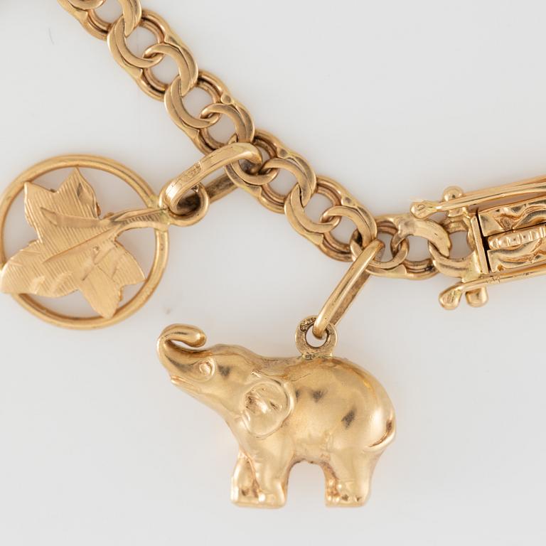 Armband 18K guld med berlocker.