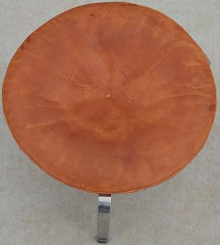 A Poul Kjaerholm steel and brown leather "PK-33" stool, E Kold Christensen, Denmark, maker's mark in the steel.