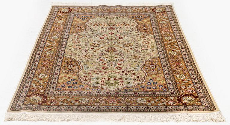 A double-nisch silk Hereke rug, c. 125 x 78 cm.
