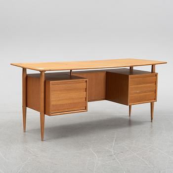 A teak veneered writing desk, 1950's/60's.