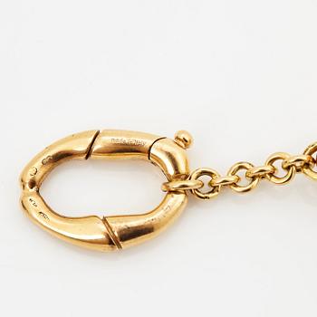 An 18K gold Gucci bracelet.