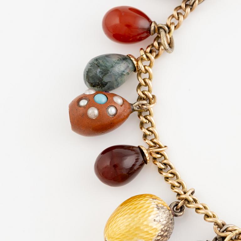Bracelet with charms in the shape of eggs, the bracelet is 14K gold and 13 loose charms in the shape of eggs.