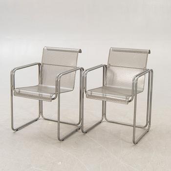 A pair of metal 1970/80s armchairs.