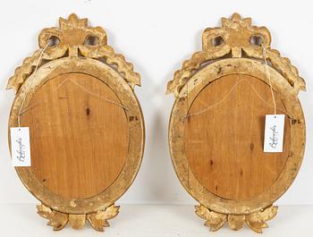 A pair of Gustavian style two-light giltwood girandole mirrors, 20th century.