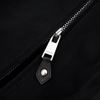 HERMÈS, a black nylon bag with leather details.