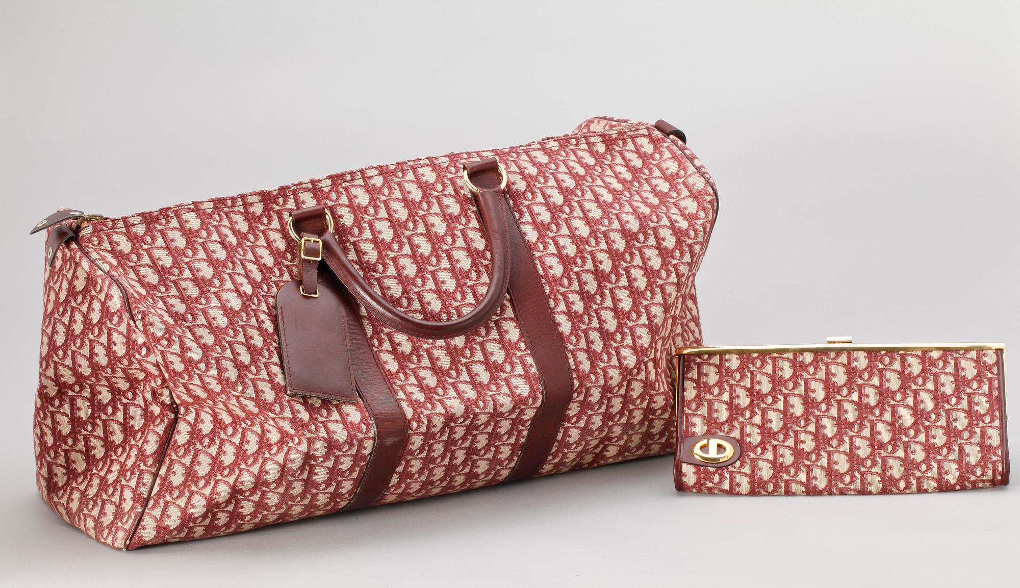 A red monogram canvas weekendbag and clutch by Christian Dior.