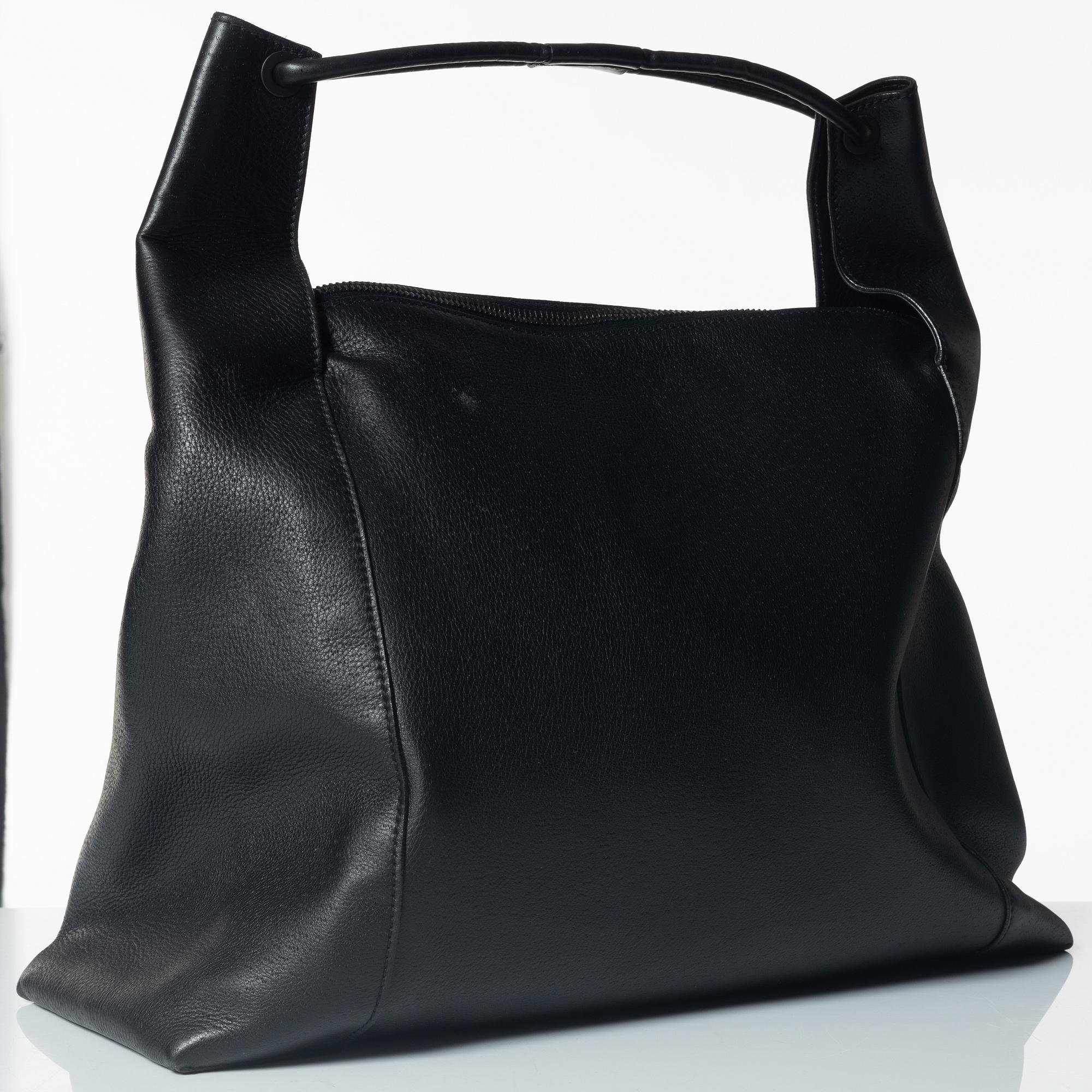 Gucci, A black leather hobo bag.