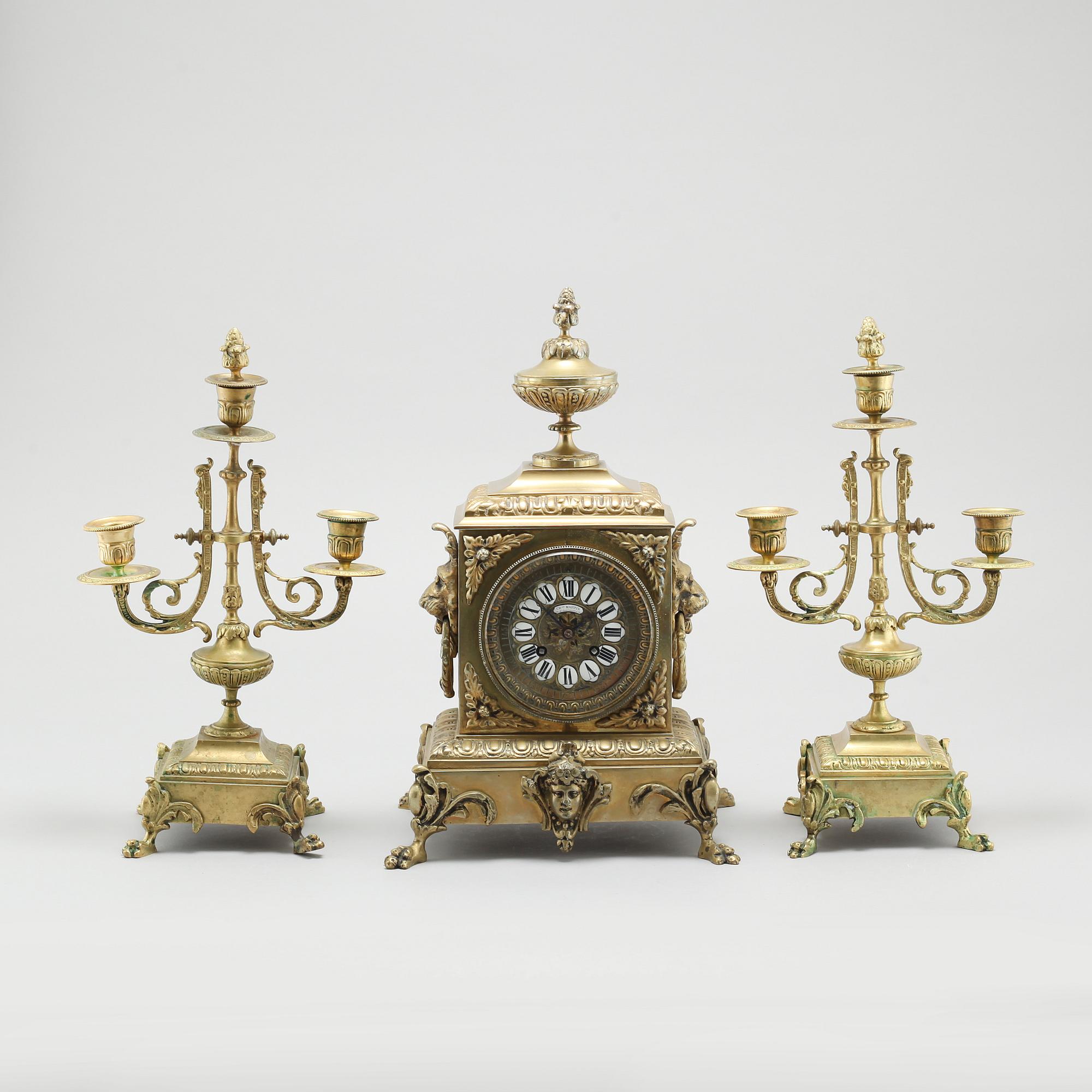 A table clock and two candelabras, around the year 1900.