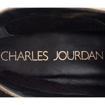 CHARLES JOURDAN, a pair of black suede and gold colored leather sneakers.