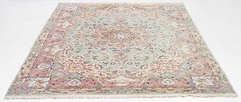 A Tabriz carpet, part silk, approx. 367 x 250 cm.