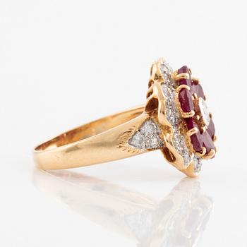 An 18K gold, ruby and round brilliant cut diamond flower ring.