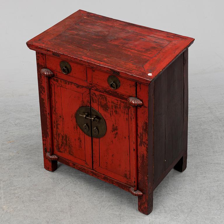 A red lacqured Chinese cabinet, 20th Century.
