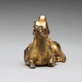 A gilt bronze figure of a reclining mythical animal, Qing dynasty, 19th Century.