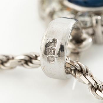 Pendant in 18K white gold with a faceted sapphire and round brilliant-cut diamonds.