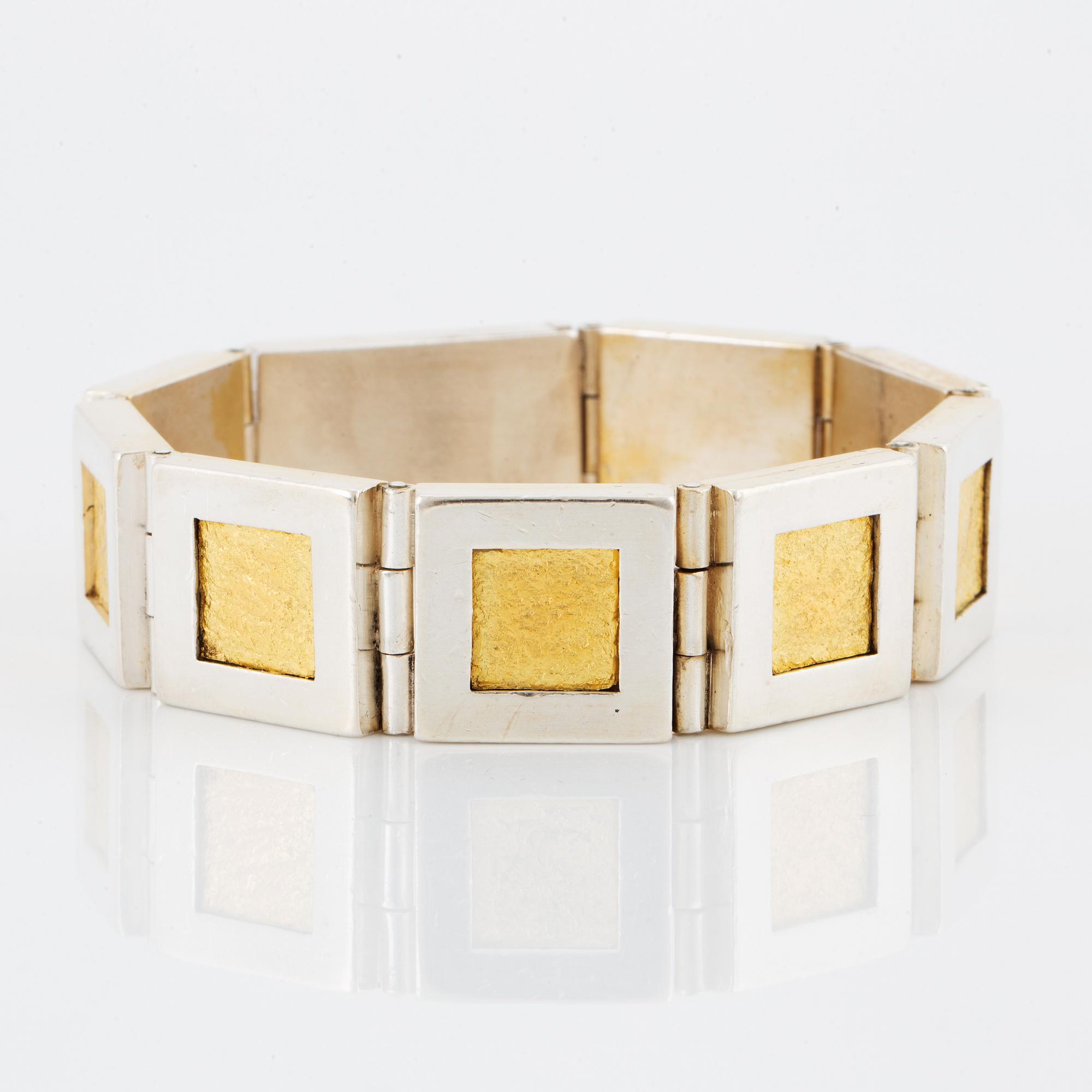 A Michael Hamma bracelet in silver and 18K gold.