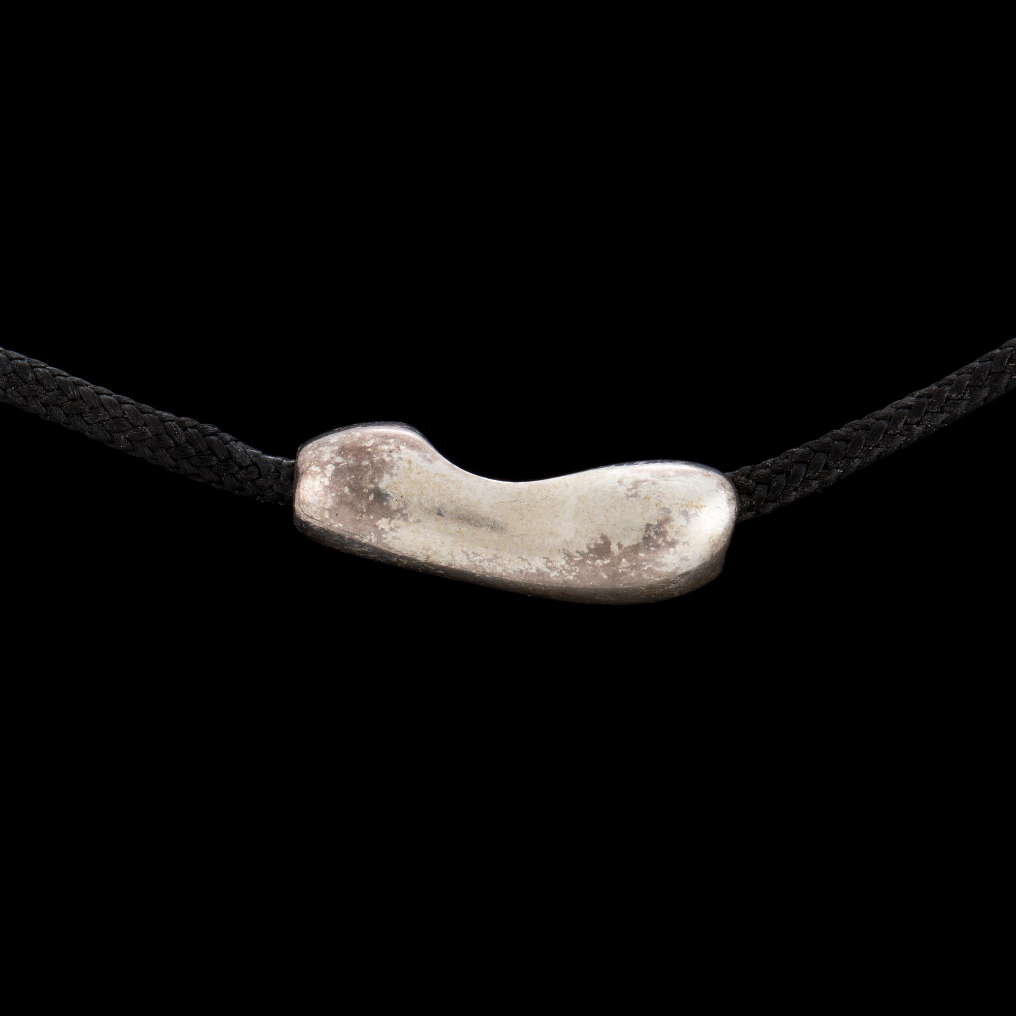A silver and gold pendant by Minas Spiridis for Georg Jensen, designed in the 1990's.