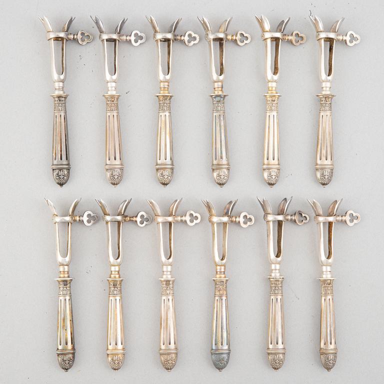 A set of six French silver pork chop holders, circa 1900.
