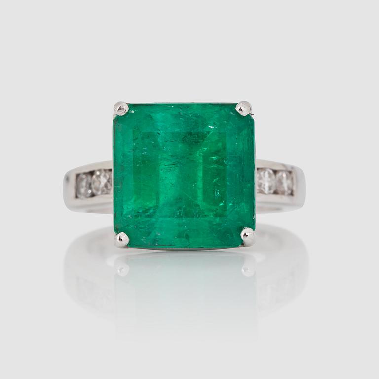 A step-cut emerald, circa 9.00 cts, and brilliant-cut diamond ring.