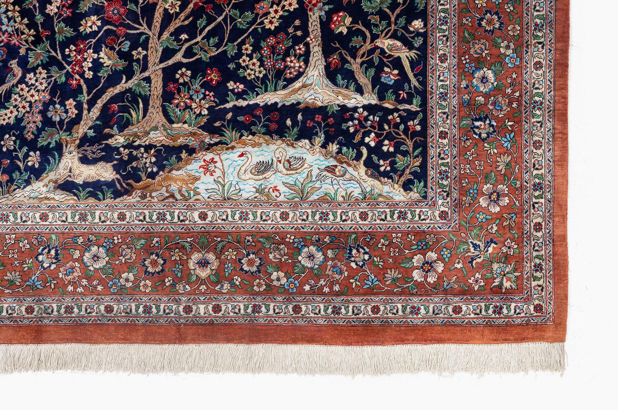 A signed pictoral silk Qum rug, c. 203 x 127 cm.