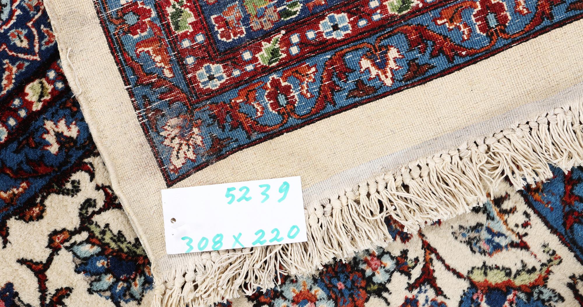 An oriental carpet, c. 308 x 220 cm.