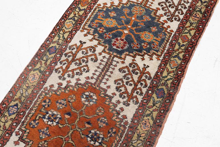 An oriental runner, c. 395 x 82 cm.