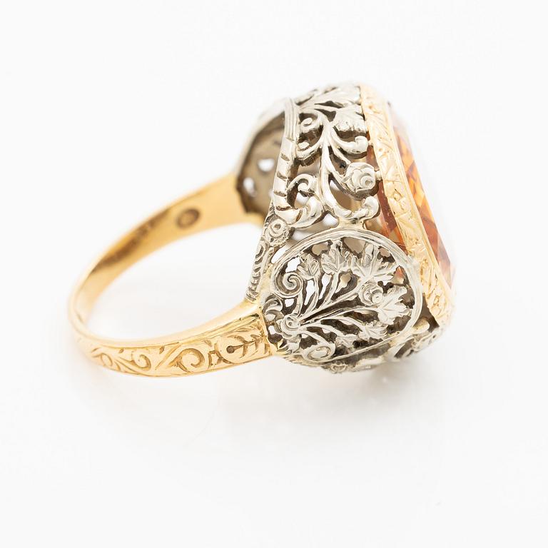Gold ring with synthetic yellow sapphire.