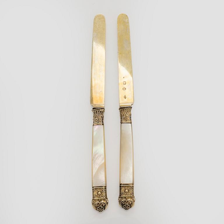 A set of eleven gilt silver dessert knives with mother-of-pearl stems, Paris 1819-1838.
