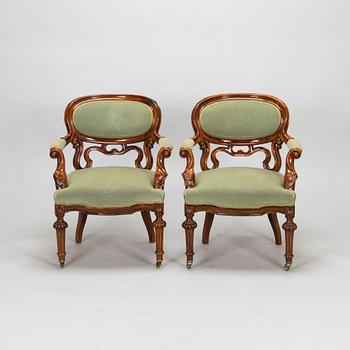 A pair of Russian armchairs and a table, late 19th century.
