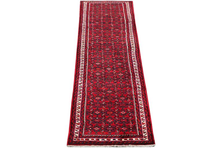 An oriental runner carpet, c. 395 x 87 cm.