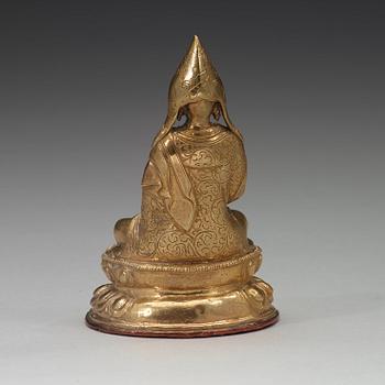 A Tibetan copper alloy figure of a Lama, circa 1900.