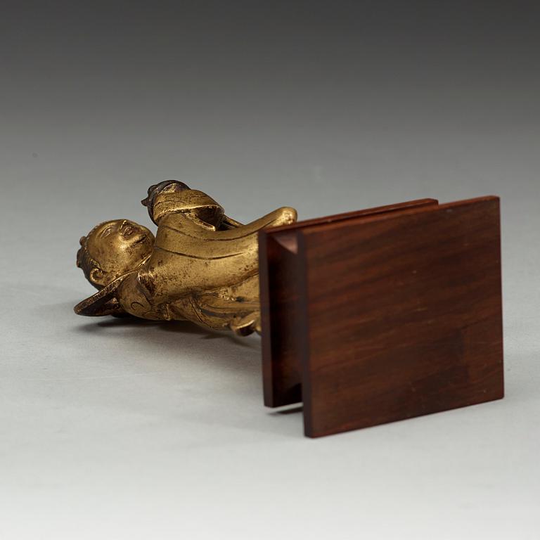 A gilt bronze figure of Longnü, Ming Dynasty, 17th century.