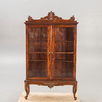 A 1940s Rococo style display cabinet.