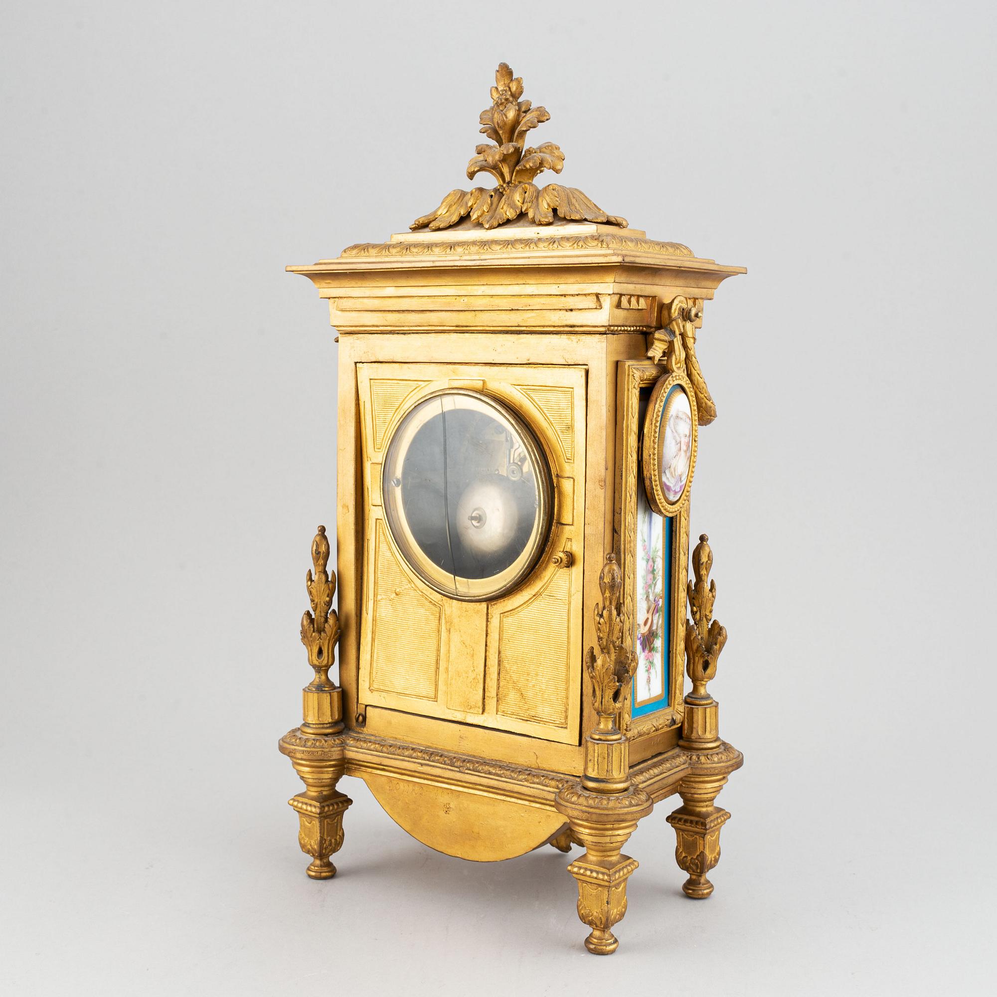 A late 19th century table clock and candelabra, probably France.