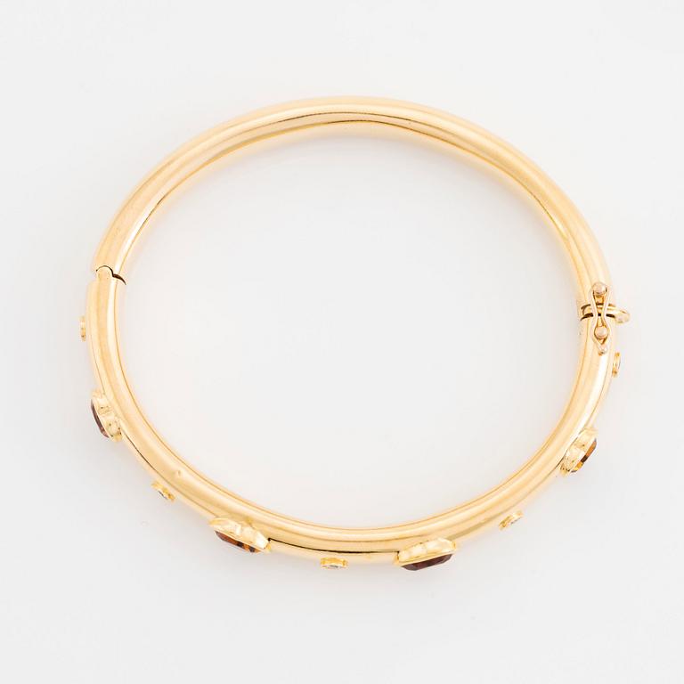 An 18K gold David Morris bangle set with citrines and round brilliant-cut diamonds.