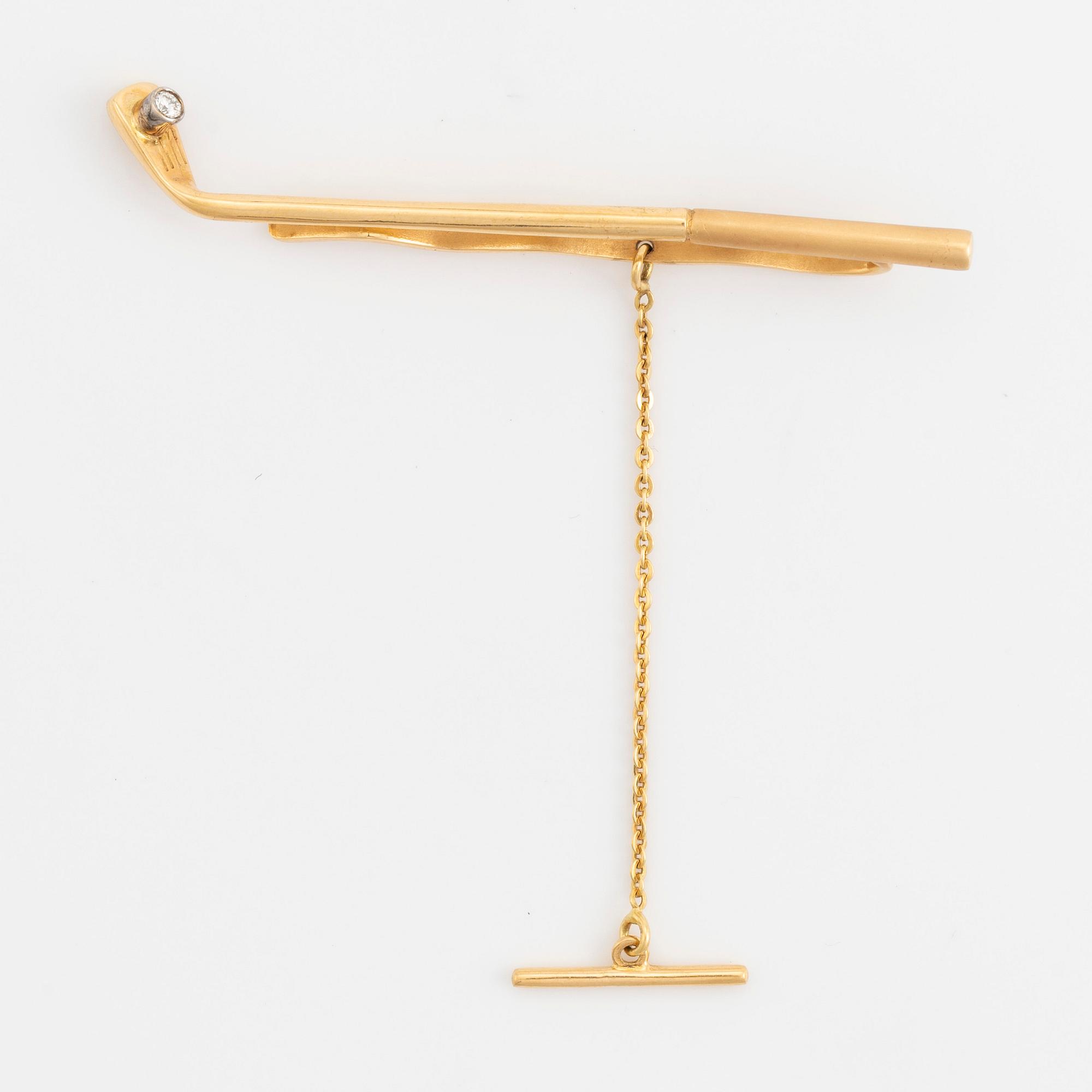 Slipsnål, 18K guld med briljantslipad diamant, i form av en golfklubba.